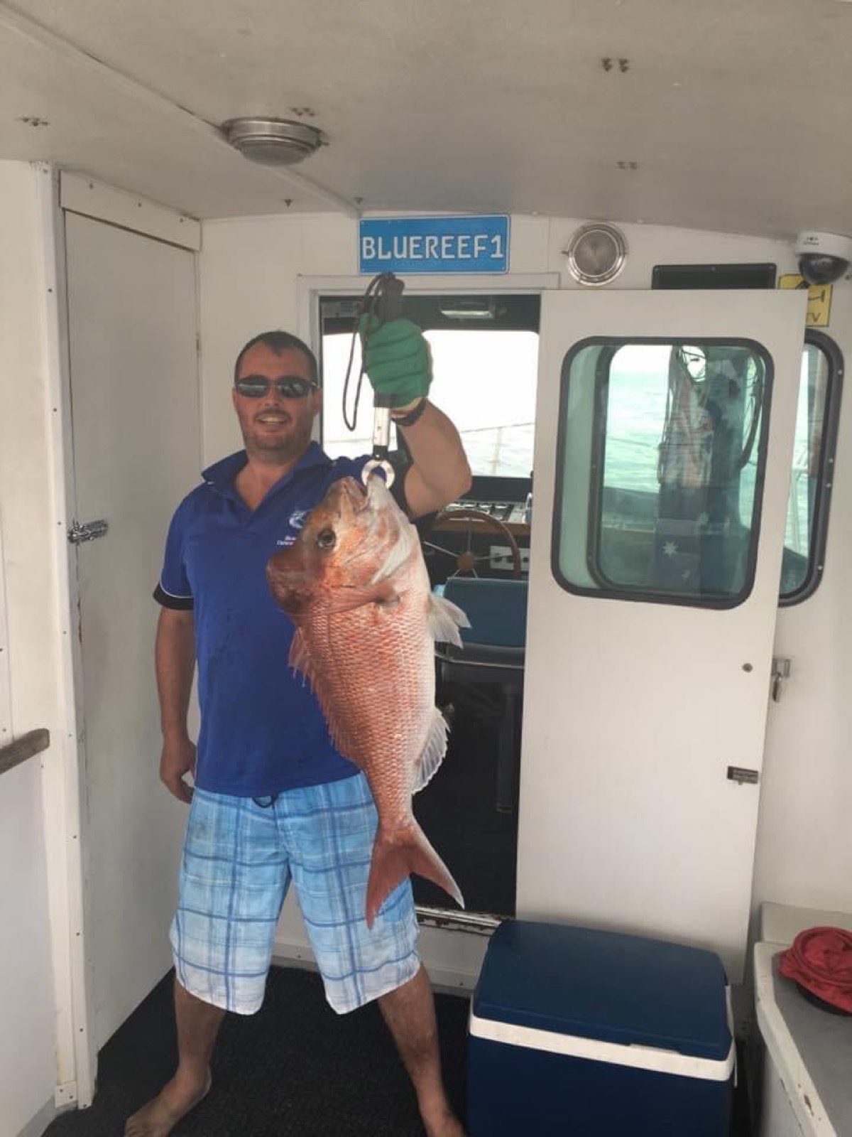 An angler with a kingfish aboard